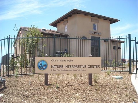 Dana Point Nature Interpretive Center with the sign in front and the building behind